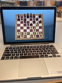 a laptop computer with a chess game on it