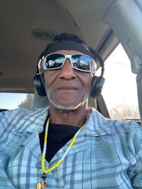 a man wearing headphones in a car